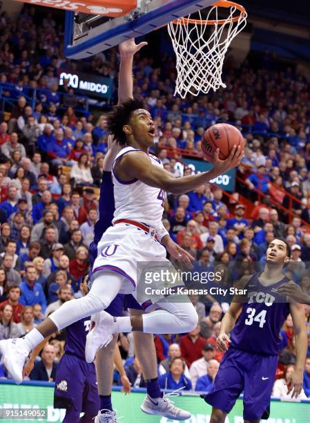 S Devonte' Graham, who had a game-high 24 points, drove by TCU's Vladimir Brodziansky for a reverse layup during the second half at Allen Fieldhouse...