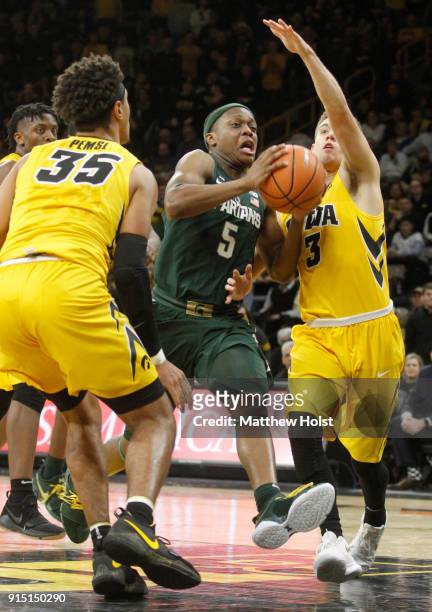 Guard Cassius Winston of the Michigan State Spartans goes to the basket during the second half between forward Cordell Pemsl and guard Jordan...