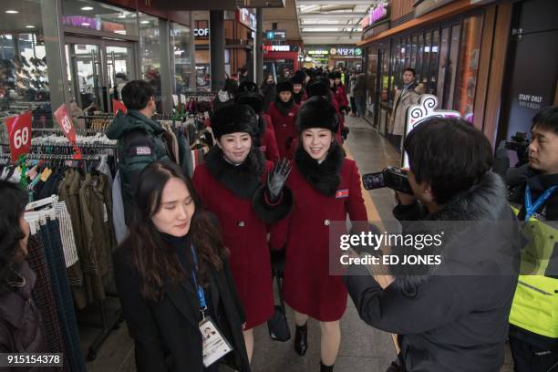 North Korean cheerleaders arrive at a rest stop, or service station, as their bus convoy carrying a 280-member delegation on its way to the 2018...