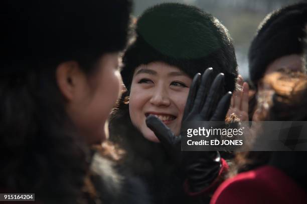 North Korean cheerleaders arrive at a rest stop, or service station, as their bus convoy carrying a 280-member delegation on its way to the 2018...