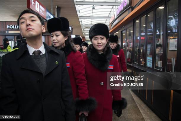 North Korean cheerleaders arrive at a rest stop, or service station, as their bus convoy carrying a 280-member delegation on its way to the 2018...