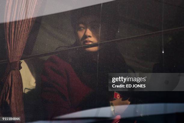 North Korean cheerleader sits aboard a bus as their convoy arrives at the Inje Speedium resort complex, where they are staying during the Pyeongchang...