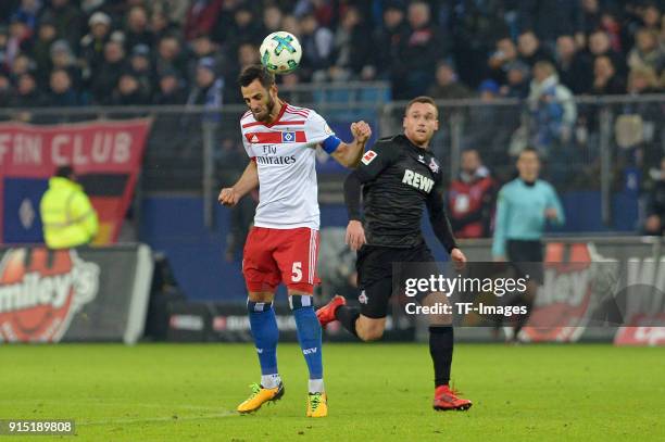 Mergim Mavraj of Hamburg and Christian Clemens of Koeln battle for the ball during the Bundesliga match between Hamburger SV and 1. FC Koeln at...