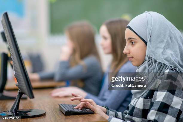 muslim girl using computer - islamic school stock pictures, royalty-free photos & images
