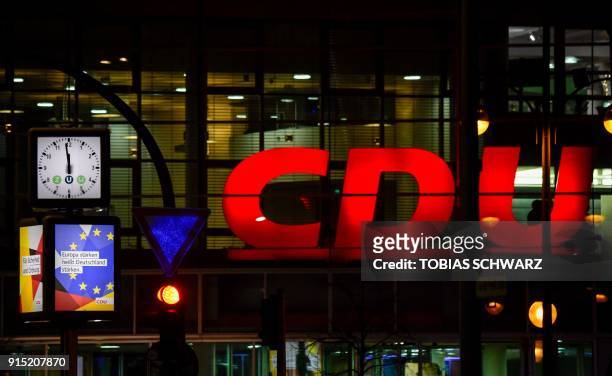 Clock displays almost midnight in front of the Christian Democrats headquarters on February 6, 2018 in Berlin as negotiators from German chancellor's...