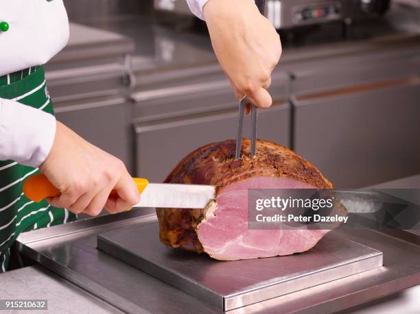 chef carving ham joint in a restaurant - ham imagens e fotografias de stock
