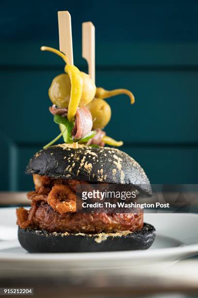 Bocata de calamares", Housemade Chorizo Burger, Crispy Wild Calamari & Piparras Alioli at Del Mar restaurant at The Wharf in Washington, DC on...