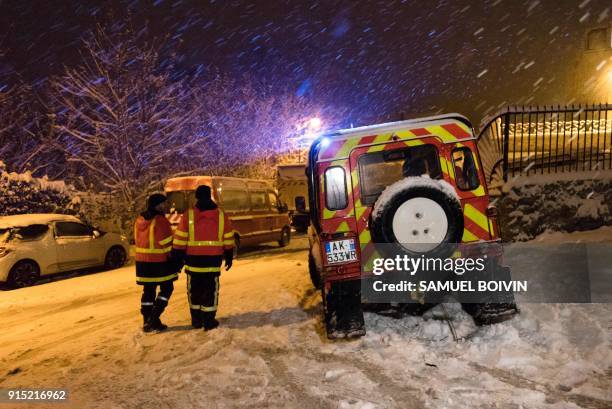 French firemen take part in a shelter operation for the people stranded by the snow on the road, at the entrance of Bievres, southwest of Paris,...