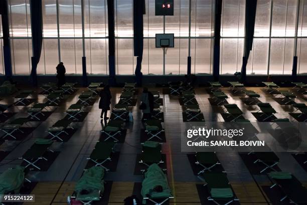 People who were stranded by the snow on the road, rest in an emergency shelter installed at the Robert Wagner gymnasium in Velizy-Villacoublay,...