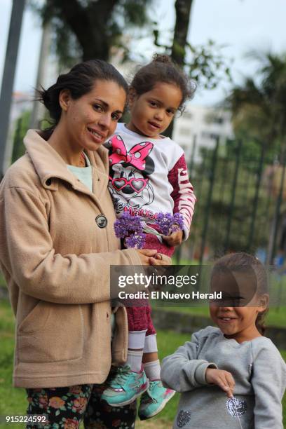 Esperanza Tello holds her baby, Ediangelis Alexandra Rojas, and poses with her daughter, Edilianys Rojas, outside a bus terminal in Bogota, Colombia.
