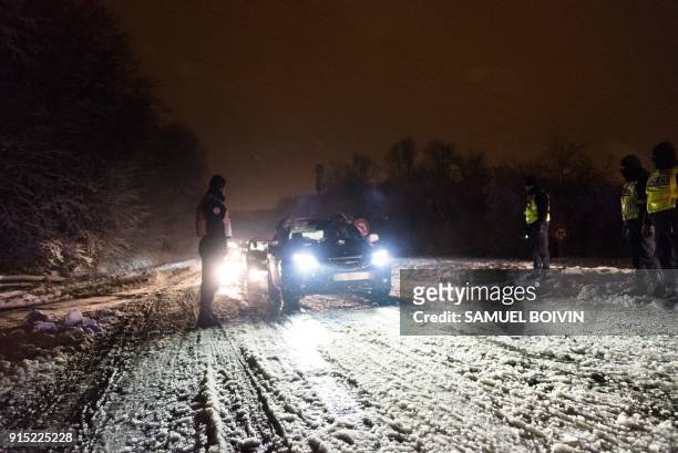 Stranded vehicles stand on the blocked D444 road near Bievres, southwest of Paris, early February 7 after heavy overnight snowfall in northern...