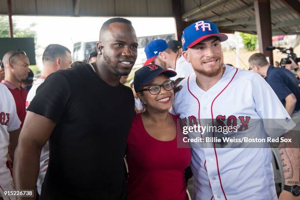 Rusney Castillo and Christian Vazquez of the Boston Red Sox pose with a fan during a Boston Red Sox hurricane relief trip from Boston, Massachusetts...