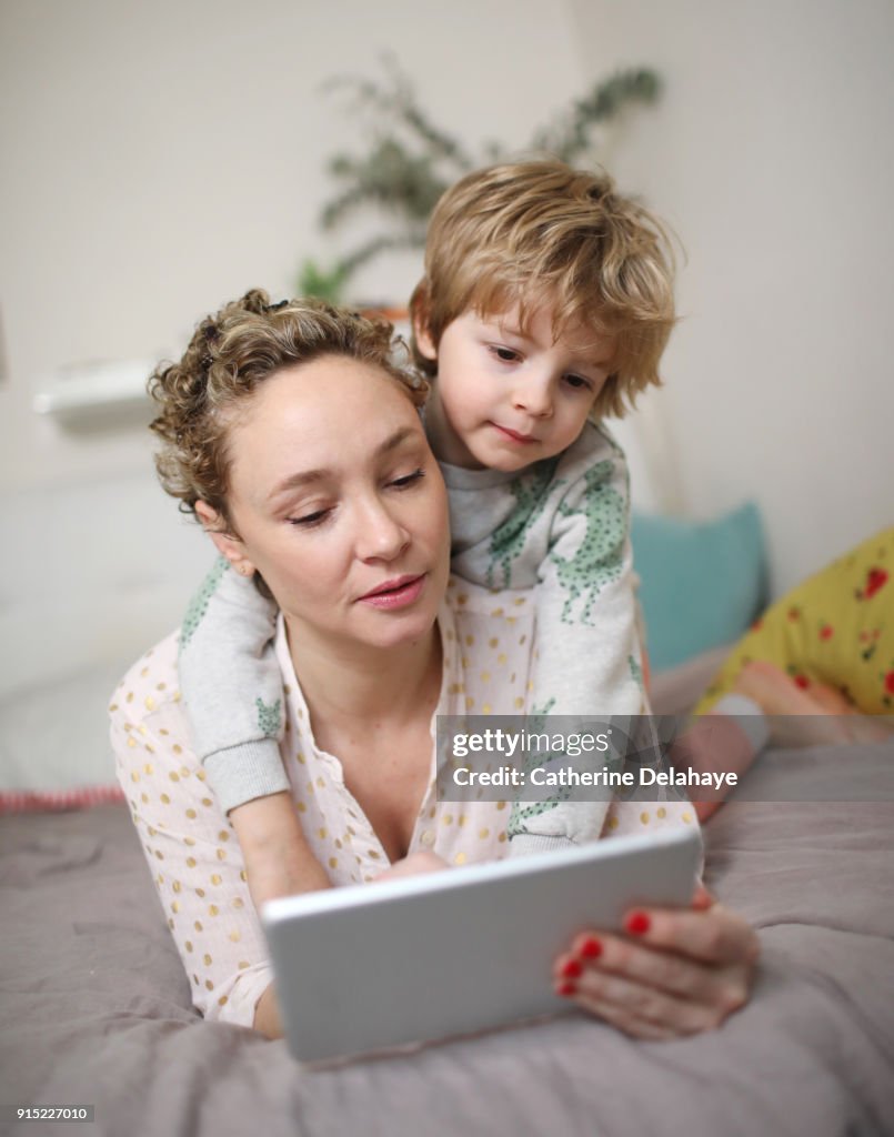 A mum and his son watching a tablet