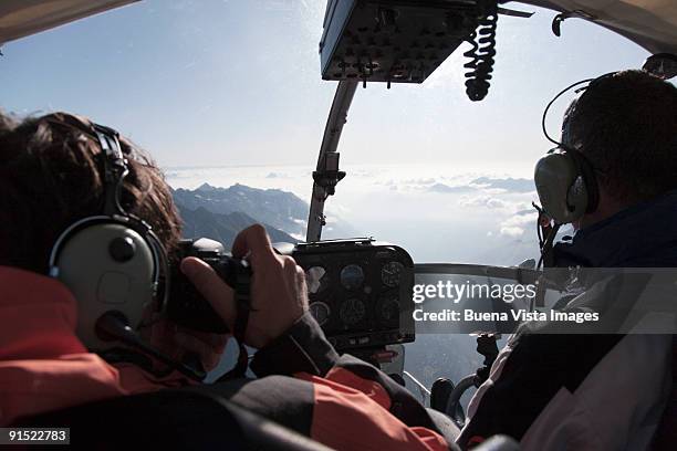 photographer aboard lama helicopter - inside helicopter stock pictures, royalty-free photos & images