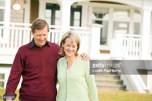 mature couple walking in front of their house - white rock columbia britannica foto e immagini stock