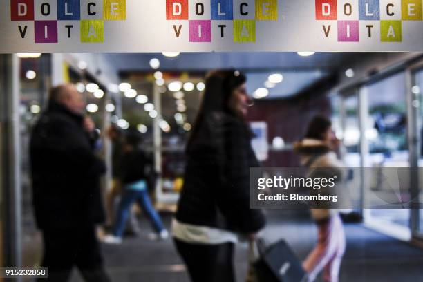 Visitor passes colorful signage at the entrance to the Dolce Vita Tejo shopping mall, operated by AXA Real Estate Investment Managers SGR SpA, in...