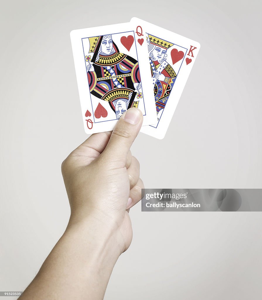 Young woman holding playing cards 