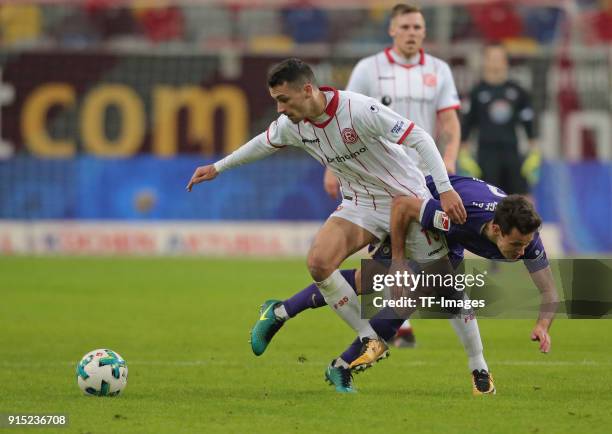 Davor Lovren of Duesseldorf and Clemens Fandrich of Aue battle for the ball during the Second Bundesliga match between Fortuna Duesseldorf and FC...