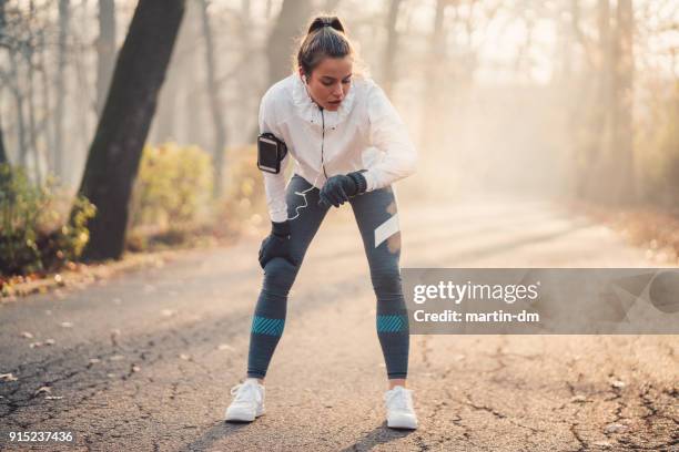 sportswoman using fitness tracker - sprint phone stock pictures, royalty-free photos & images