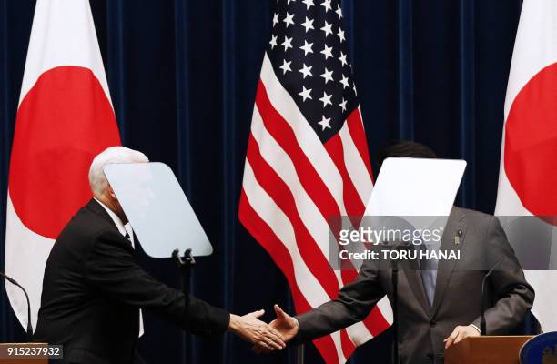 Vice President Mike Pence and Japan's Prime Minister Shinzo Abe shake hands during their joint announcement after their meeting at Abe's official...