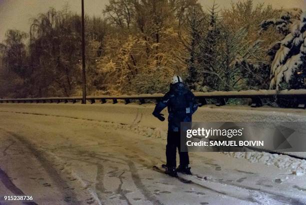 Person is skiing on the deserted and snow-covered N118 main road near Velizy-Villacoublay overnight on February 6 after its closure following heavy...