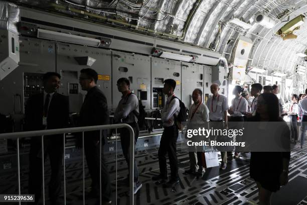 Attendees stand inside a United States Air Force C-17 Globemaster III aircraft, manufactured by Boeing Co., at the Singapore Airshow in Singapore, on...