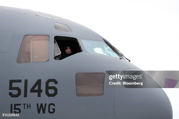 Visitor sits inside the cockpit of a United States Air Force C-17 Globemaster III aircraft, manufactured by Boeing Co., during the Singapore Airshow...