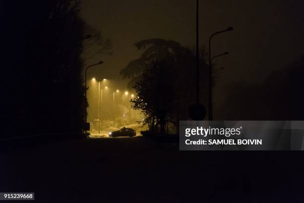 French gendarme vehicle blocks the snow-covered N118 main road near Velizy-Villacoublay overnight on February 6 after its closure following heavy...