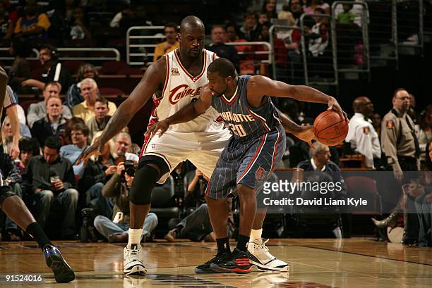 Shaquille O'Neal of the Cleveland Cavaliers guards Raymond Felton of the Charlotte Bobcats at The Quicken Loans Arena on October 6, 2009 in...