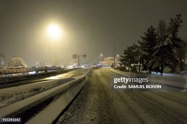 The snow-covered N118 main road is deserted near Velizy-Villacoublay overnight on February 6 after its closure following heavy overnight snowfall in...