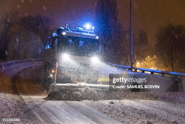 Snowplough clears the snow from the snow-covered N118 main road near Velizy-Villacoublay early February 7, 2018 after its closure following heavy...