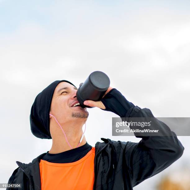 young sportsman drinking water at training. - protein shaker stock pictures, royalty-free photos & images