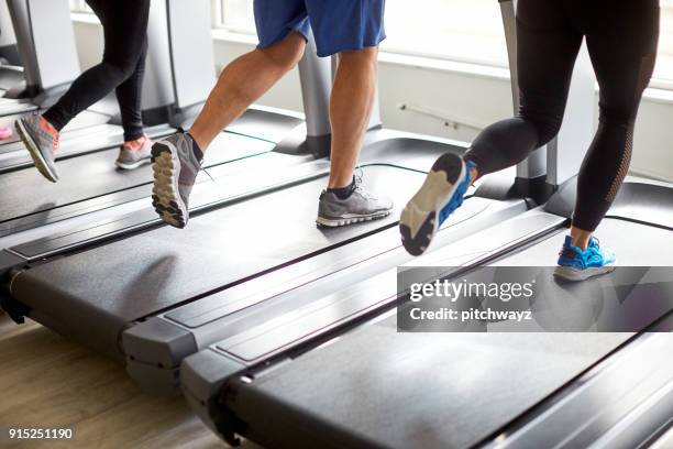 unrecognized people running on treadmill. - running spikes stock pictures, royalty-free photos & images