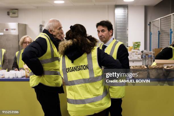 Velizy-Villacoublay's mayor, Pascal Thévenot , speaks with volunteers, as people who were stranded by the snow on the road, arrive in an emergency...