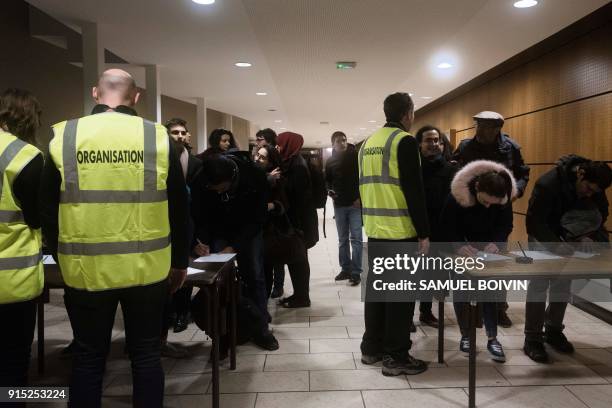 People who were stranded by the snow on the road, arrive in an emergency shelter installed at the Robert Wagner gymnasium in Velizy-Villacoublay,...