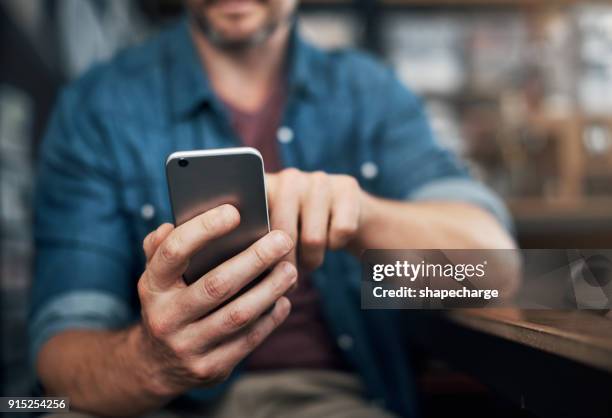 checking in on texts from clients - smart phone on table stock pictures, royalty-free photos & images