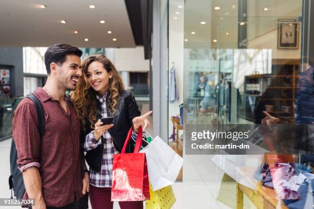couple in the shopping center - window display stock pictures, royalty-free photos & images