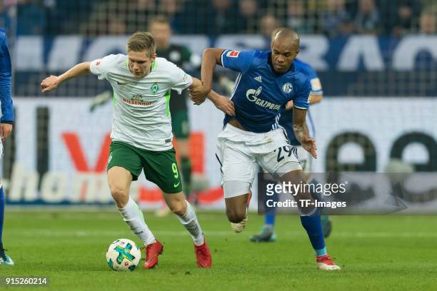Aron Johannsson of Bremen and Naldo of Schalke battle for the ball during the Bundesliga match between FC Schalke 04 and SV Werder Bremen at...