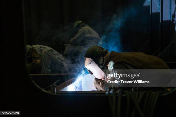 an iron worker welding in a shipbuilding factory - toughness stock pictures, royalty-free photos & images