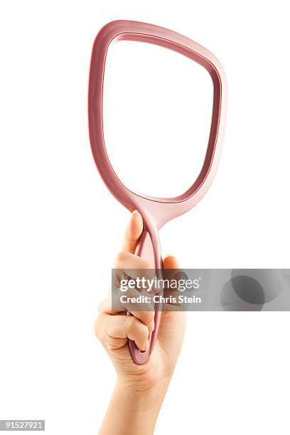 woman holding a hand mirror - woman holding hand mirror stock pictures, royalty-free photos & images