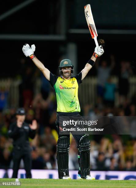 Glenn Maxwell of Australia celebrates his century after hitting a six from the last ball during the Twenty20 International match between Australia...