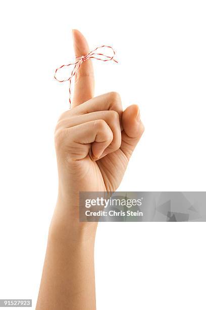 woman with a string tied on her finger with a bow - woman index finger stock pictures, royalty-free photos & images