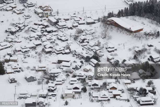 Photo taken Feb. 7, 2018 from a Kyodo News airplane shows houses and buildings in Echizen, Fukui Prefecture, covered by heavy snow that hit a wide...