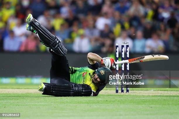 Glenn Maxwell of Australia falls after diving to make his ground during the Twenty20 International match between Australia and England at Blundstone...