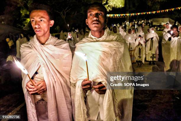 Pilgrims pray by candlelight. The annual Timkat festival, an Orthodox Christian celebration of Epiphany, remembers the baptism of Jesus in the Jordan...