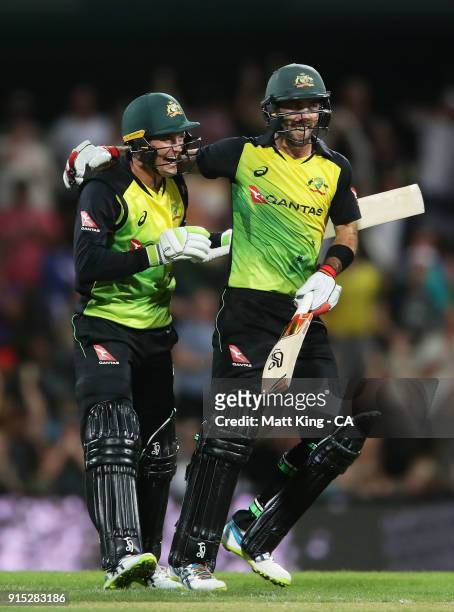Glenn Maxwell of Australia celebrates victory with Alex Carey after scoring a century during the Twenty20 International match between Australia and...
