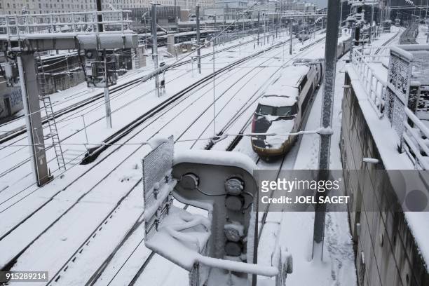 Picture taken on February 7, 2018 in Paris shows snow covered railways . - Exceptionally heavy snowfall brought public transport in Paris and...