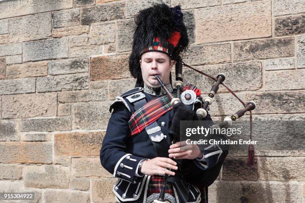 Edinburgh, Scotland Bagpiper on The Royal Mile in Edinburghs Old Town playing for tourists.