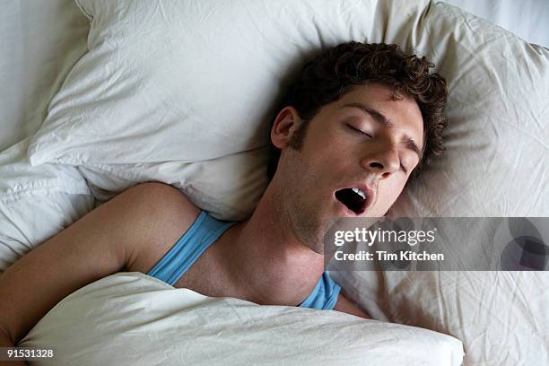 man sleeping and snoring, overhead view - sleeping man foto e immagini stock