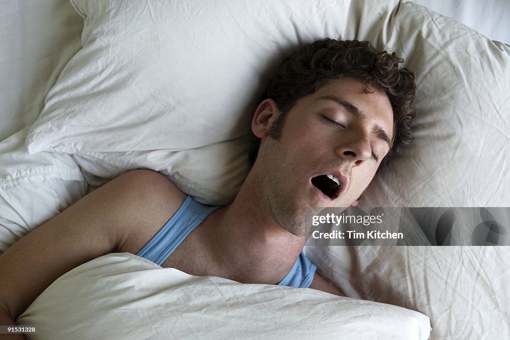Man sleeping and snoring, overhead view